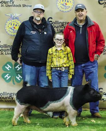 Tatum Martin displays her fourth-place class 1 cross swine with buyer Buzzard Roost Farms, represented by Jeremy Page and Danny West.