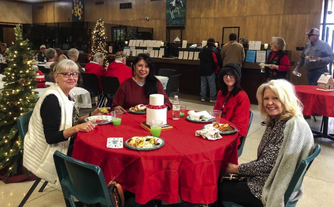 Wellington State Bank patrons gather for food and fellowship during the 11 a.m.-2 p.m. Christmas Open House last Thursday, Dec. 5. From left, Doris Wilbur, Cathy Andrews, Alex Bohn and Patsye Dodge.