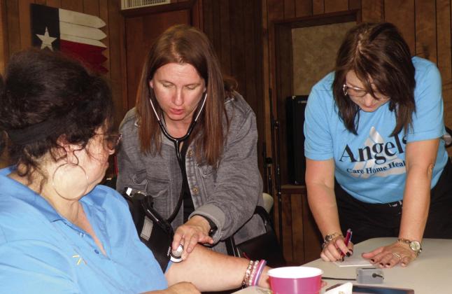 Michelle Hibbs, left, recently receives a blood pressure check at the Childress Senior Citizens Center. Making their monthly visit to the center are Angels Care Home Health of Vernon Branch Manager Kristen Horn, RN, center, and Account Executive Melissa Conner, right. Both assisted with the weekly noontime meal and explained the services Angel Care Home Health offers to assist the elderly in remaining in their own homes. Photo by Grace Holman