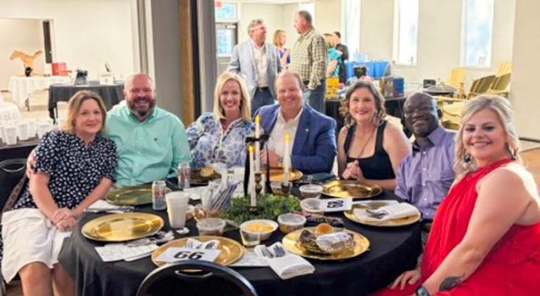 Court Appointed Special Advocates (CASA) of the Rolling Plains supporters, including Josh and Candice Talley, Meme Bass, Jack Owens, Joanna and Roman Buckner and Jill Lindsey, all of Memphis, partake in the Saturday, May 2 Gala festivities at the Wellington Community Center. Visitors in the background shop the diverse selection of silent auction items. COURTESY PHOTO