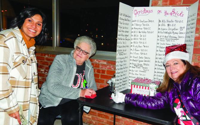 Collingsworth Chamber of Commerce volunteers Nancy Harris and Margret Wood sell Christmas on the Bricks Red Tickets, for a $10 donation per ticket, to Becky Reyes, left, during the Lighting of the Square event last Saturday evening, Dec. 3. The famous courthouse star even appeared around dusk as Santa and Mrs. Claus gave the signal for the lighting. The Red Ticket drawing will take place at 5 p.m. Saturday, Dec. 17 at Collingsworth County Museum. The Red River Sun/Bev Odom