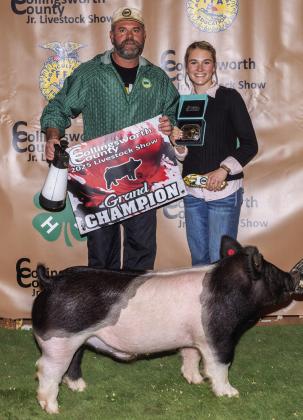 Maggie Tillman exhibits the Grand Champion Swine, assisted by her dad, Baron Tillman, and purchased by Rance Tillman at the Premium Sale.