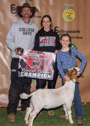 Raylie Sims shows the Reserve Grand Champion Goat, congratulated by her parents, Sawyer and Molly Sims, and purchased by Jeremy and Katie Page at the Premium Sale.