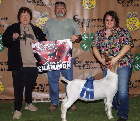 Brecklyn Powell exhibits the Grand Champion Goat, assisted by her parents, Candy and Jeff Powell, and purchased by Kathy Fowler at the Premium Sale.