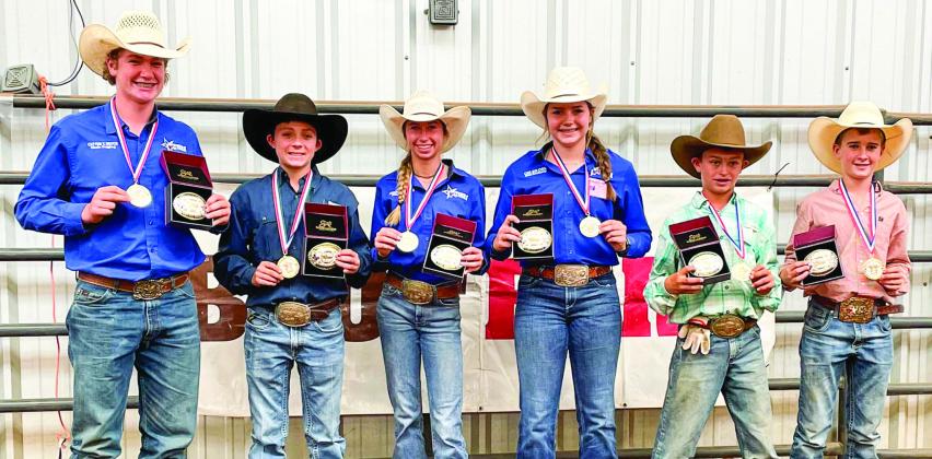 Region 1 members Cutter Bruce, of Childress, left, Hazen Lamb, of Borger, Avery Armstrong, of Borger, Colee Cox, of Tell, Rhyder Rosipal, of Miami, and Slayde Stalls, of McLean, receive their Team Texas World Championship buckles and medals at the Region 1 Texas Junior High Rodeo Saturday, Oct. 22. The Red River Sun/Elizabeth Tanner