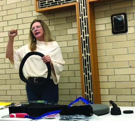 Texas Department of Transportation Traffic Safety Specialist Nicole Tyler demonstrates an array of CarFit tech specific items for drivers over the age of 62. She describes how a nonslip steering wheel cover can make someone over 62-years-old a safer driver.