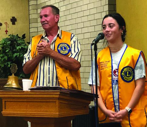 Wellington Boss Lion Jeff Thomas, left, presents Sweetheart Summer Owens her Lions Club vest during the Sept. 19 meeting. Owens gave an update on her recent activities.