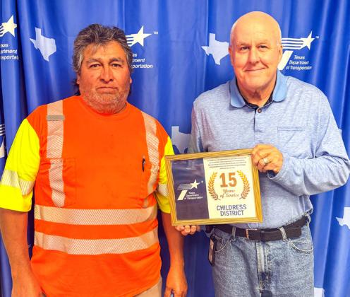 Childress District of the Texas Department of Transportation Engineer Darwin Lankford presents a 15-year service award to Raul Rojas, Childress County maintenance. Additional 15-year recipients included Chris Wiley, Cottle County Assistant Maintenance Supervisor.