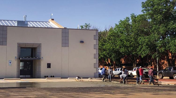 Contractors smooth wet cement Monday, May 1 to extend the parking area on the north side of Wellington Senior Citizens Center, 906 Amarillo St. The Red River Sun/Bev Odom