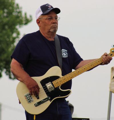 Childress Fire Department’s Roger Adams plays the bass guitar during the recent benefit concert.