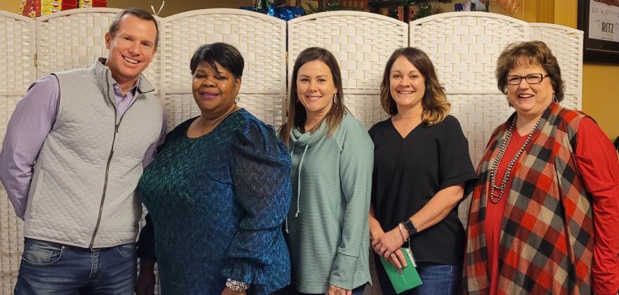 Preferred Management Corporation Vice President Jared Chanski, left, and Collingsworth General Hospital (CGH) Administrator Candy Powell, right, salute Amanda Townsend’s 15 years of service to CGH, Kendra King’s 10 years and Kendra Hedrick’s 15 years.