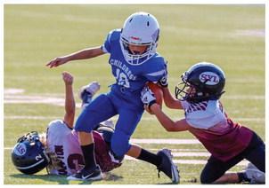 The Childress Youth Recreational League (CYRL) third- and fourth-grade Lil Cats tackle football teams recently take the field against the Sayre Eagles. Photos by Elizabeth Gamboa