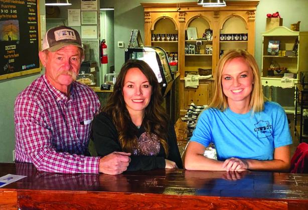 Kent and Shannon Rollins, along with Director of Operations Shari Reyna, clinch a quiet moment in their busy lives at Kent Rollins’ Cowboy Coffee shop Tuesday morning, Oct. 25 in downtown Wellington. The Red River Sun/Bev Odom