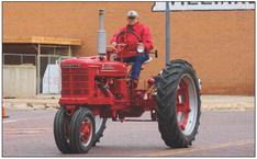 Local farmer and antique tractor extraordinaire Kenneth Ellis, 92, drives his 1950 McCormick Farmall tractor during the annual Old Settlers Parade Saturday morning, April 22.
