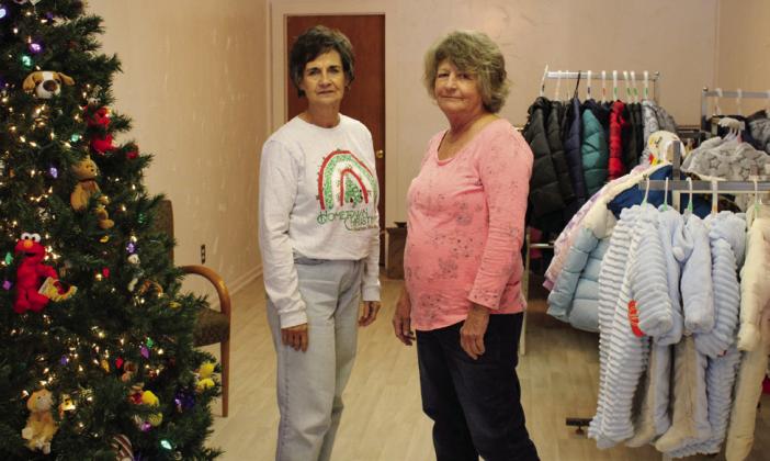 Childress County Christmas Sharing (CCCS) volunteers Raenell Smith, left, and Durlene Worthington display coats that will be given to those in need this holiday season. Currently accepting applications, families are encouraged to sign up at the CCCS office, located at 232 Main St. The Red River Sun/Elizabeth Tanner