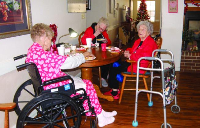 Cottage Village Assisted Living Facility residents, including Becky Sims, left, Billie SimmonsandCharlotteAlsord,listentomusic, played by Joe Robinson, while enjoying an assortment of special refreshments, during a mid-afternoon Valentine’s Day party Friday, Feb. 14 in Childress. Photos by Grace Holman