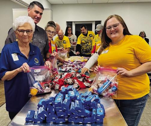 Lions from across the Texas Panhandle join in packaging Wellington’s Snack Packs for Seniors during the recent District 2-T1 Fall meeting.