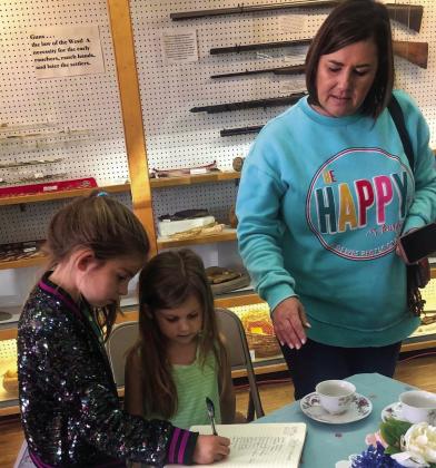 Jenna Kate Faulks, 7, and Adeline Reese Faulks, 5, with their grandmother, D’Nae Souder, signed the guestbook and enjoyed refreshments, including cupcakes, assorted nuts and hot tea served from an antique cup collection. The trio also strolled through the doll exhibit in the Collingsworth County Museum’s Ellis Art Center. Located at 824 East Ave., visit the vintage doll collection during normal business hours, 11 a.m.-4 p.m., Tuesday-Friday. Courtesy Photos