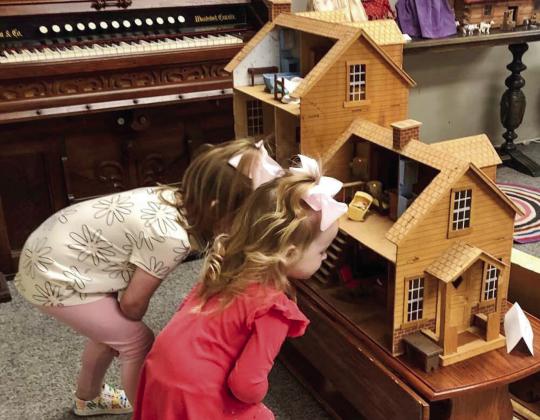 Kollins LoRhae Jones, 4, and Addison James Jones, 2, visited the doll exhibit and attended the tea party with their mother, Rhae Jones, and great-grandmother, Nancy Harris. The girls especially showed appreciation for the dollhouse kit, which was ordered from Sears &amp;amp; Roebuck by Phyllis Floyd for her daughters in 1979. Her husband, Ray Floyd, assisted in assembling the life-like house replica and intricate furniture.