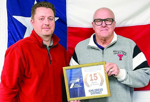 Childress District of the Texas Department of Transportation’s (TxDOT) Steven Ferguson, left, is honored for 15 years of service by TxDOT Childress District Engineer Darwin Lankford.