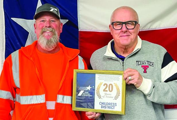 Childress District of the Texas Department of Transportation’s (TxDOT) Jeremy Black, left, celebrates 20 years of service, receiving an award from TxDOT Childress District Engineer Darwin Lankford.