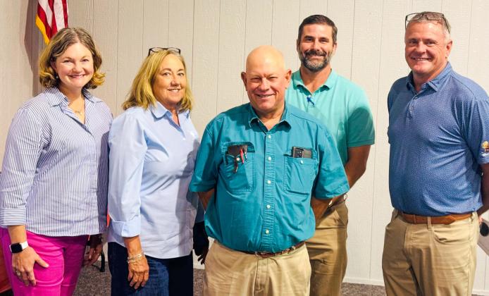 Tri-County Co-Op Gin Manager Jeff Camp, center, expresses his appreciation to the special guests who traveled to Dodson for the Thursday, Aug. 21 annual meeting. From left: Lauren Decker, of Stamford, Rolling Plains Cotton Growers; Shelly Henrich, of Lubbock, Cotton Board; Chad Levings, of Altus, Triangle Insurance; Matt Monroe, of Altus, Plains Cotton Cooperative Association. Jim Ellis