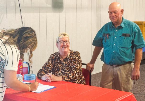 Tri-County Co-Op Secretary Linda Ellsworth registers guests with Manager Jeff Camp at the organization’s annual meeting Thursday evening, Aug. 21.
