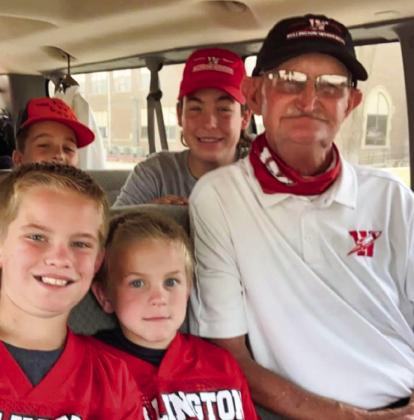 Skyrocket managers Jax Heflin, Jake Anderson, Major Brown and Caleb Strickland gather with “Coach Mike” for a photo before heading out to a football game in 2020. See page 9A for his full obituary. Photo Courtesy of Colby Anderson