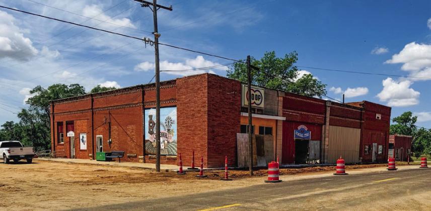 Tri-County Co-Op gin office customers utilize the east entrance as crews prepare to pour concrete for new sidewalks on the southside of FM 338 through Dodson.