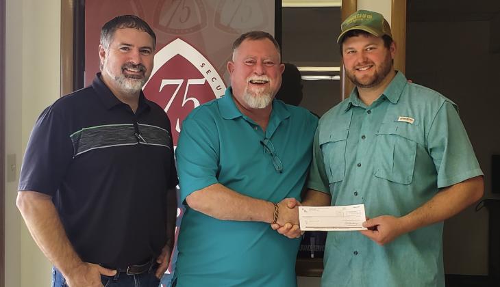 Representing Samnorwood Volunteer Fire Department, volunteer Tucker Conner, right, accepts a donation from Texas Farm Bureau Insurance, presented by Brandon Ward and Durk Green. Courtesy Photo