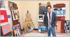Local artist Bruce Smith, whose work is often featured on cardboard canvasses, stages his work at For The Hub Of Art’s Art Show.