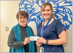 Modern Home Club President Soundra Christy donates $100 to Childress High School Family, Career and Community Leaders of America (FCCLA) Advisor Amy Detwiler.