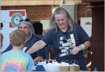The Red River Sun/Elizabeth Tanner Austin Elementary fifth-grade teachers Jennifer Widener, left, and Trisha Smith welcome students during the Back-to-School Bash Monday, Aug. 16.