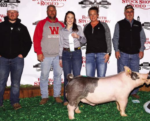 Wellington High School freshman Kenady Skelton takes 10th place with her medium weight cross swine at the Fort Worth Stock Show and Rodeo Thursday, Feb. 2. From left: Clint Newbrough, Chad Skelton, Kenady Skelton, Carrie Skelton, David Newbrough. Courtesy Photos