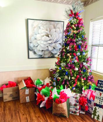 The underneath of the Christmas tree at Cottage Village Assisted Living Facility is filled with gifts for the residents, thanks to Childress County Christmas Sharing.