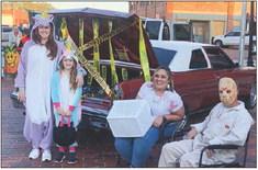 Erin and Makenzie Smith visit Mari and Nick Derr’s offlimits crime scene trunk as the couple takes the Trunkor- Treat Individual Category. Chamber President Karen Caldwell reports approximately two dozen trunks participated in the annual event. The Red River Sun/Bev Odom