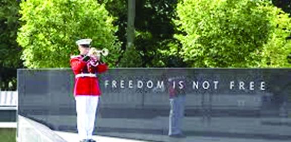 A Marine bugler participates in the Korean War Veterans Memorial Wall of Remembrance.