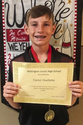 Eighth-grader Carter Ouellette accepts the Patriot’s Pen recognition for his award winning essay he composed for the contest sponsored by Glynn Moore Veterans of Foreign Wars Post 6439 Auxiliary.