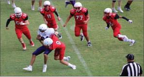 Eighth-grade Firecracker Callen Kane (8) takes down a Lynx, while Hunter Hedrick (54), Conner Bowen (11), Omar Olvera (77) and Troy Molina (6) come in for reinforcement in a 0-0 game at halftime Thursday, Sept. 15, when the game got cancelled due to weather.