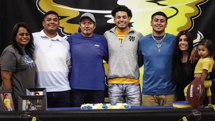 Memphis High School senior Nick Vitela signs to play collegiate-level football at Wayland Baptist University Tuesday, May 25.