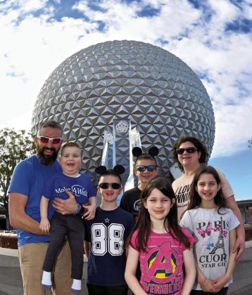 The Downing family, including Noah, left, Clive, Jack, Simon, Penny, Heather and Nora, received a Make-AWish Disney World trip to Orlando, Fla. Doctors have recommended a life-saving kidney transplant for Clive, a Head Start student at Wellington Elementary School. Courtesy Photo