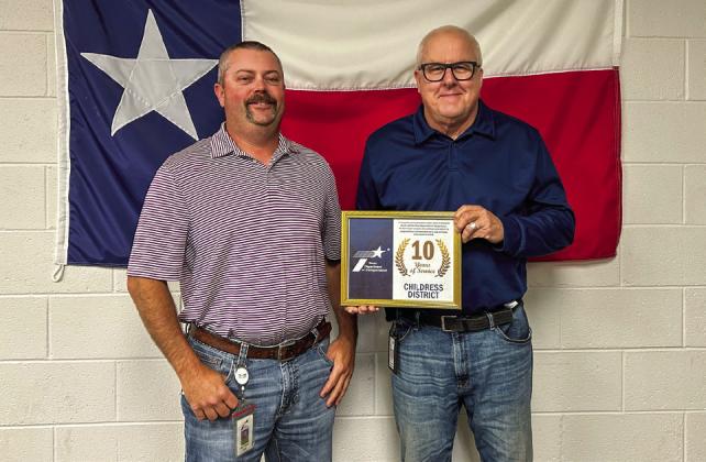 Texas Department of Transportation Childress District Engineer Darwin Lankford awards Environmental Project Planner Matt Orr for 10 years of service.