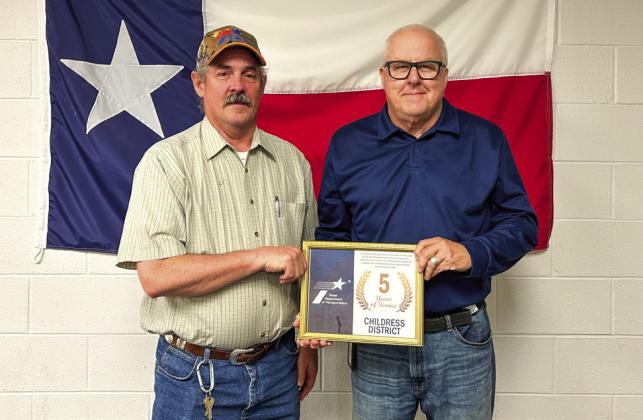 Texas Department of Transportation Childress District Engineer Darwin Lankford awards Hall County District Sign Technician Benji Adams for five years of service.