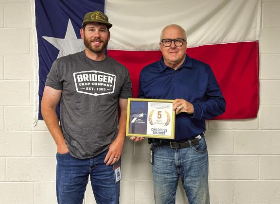 Texas Department of Transportation Childress District Engineer Darwin Lankford awards Survey Specialist Ty Wellborn for five years of service.