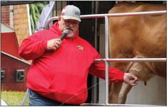 Southwest Dairy Farmers Mobile Dairy Classroom instructor Todd Griffin milks three-year-old Jersey milk cow Buttercup during Childress County Ag Day Wednesday, Oct. 26 at the Mashburn Event Center and Arena. For additional photos, see 2B. The Red River Sun/Elizabeth Tanner