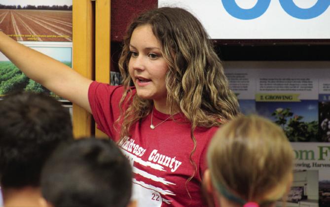 Childress High School senior Maddilynn Bryant teaches area fifth graders about cotton crops during Childress County Ag Day Wednesday, Oct. 26 at the Mashburn Event Center and Arena.