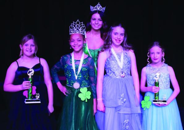 Wellington Elementary School fourth-grader Alaeja Archie, second from left, wins first place and Best Smile in the Young Miss division of the 78th Annual Shamrock St. Patrick’s Day Celebration Lad n’ Lassie Pageant Sunday, March 16, on the Shamrock High School stage. Other winners include, from left, Lainey Copenhaver, second place; Elena Barefoot, Most Photogenic; and Jade Hays, third place. Miss Irish Rose 2025 Taylor Sullivan, back, presented the honors. County Star-News