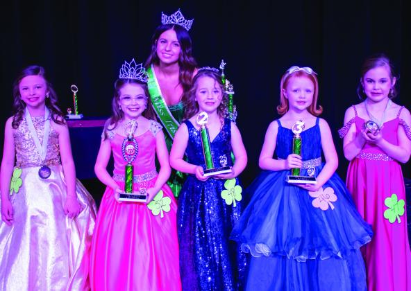 Wellington Elementary School first-grader Saige Coyne, center, receives second place in the Little Miss division of the 78th Annual Shamrock St. Patrick’s Day Celebration Lad n’ Lassie Pageant Sunday, March 16 on the Shamrock High School stage. Winners also include, from left, Jenna Robison, Best Smile; Ellison Vanderpool, first place; Renly Matthews, third place; and Claire Martin, Most Photogenic. Miss Irish Rose 2025 Taylor Sullivan, back, presented the honors.