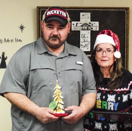 Bawcom Supply receives 130 votes to earn first place in the downtown square tree decorating contest, sponsored by Collingsworth County Chamber of Commerce. Josh Ellifritz, an employee at Bawcom’s, accepts the award from Karen Caldwell, chamber president.