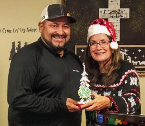 Ramon Rodriguez, owner of RLC Construction, receives the second-place tree decoration prize with 94 votes, presented by Karen Caldwell, chamber president.